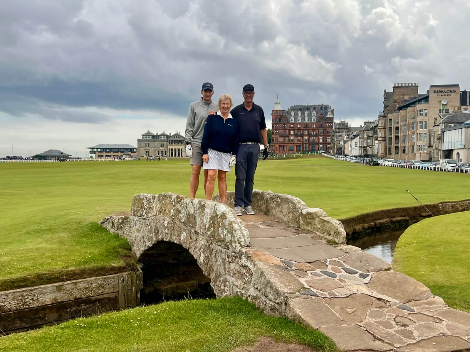 Golfers standing on the Swilcan Bridge in St Andrews