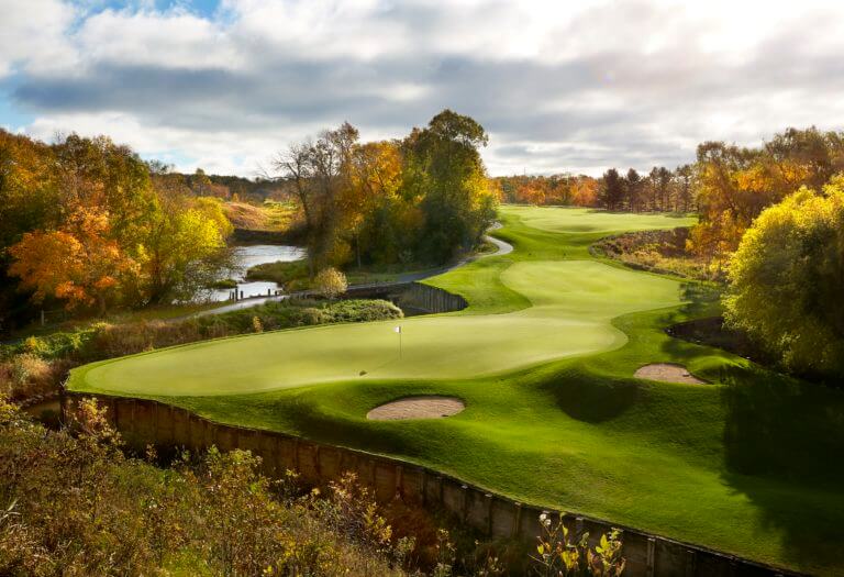Image looking down at the 14th hole green and autumn trees, Destination Kohler, Wisconsin, USA