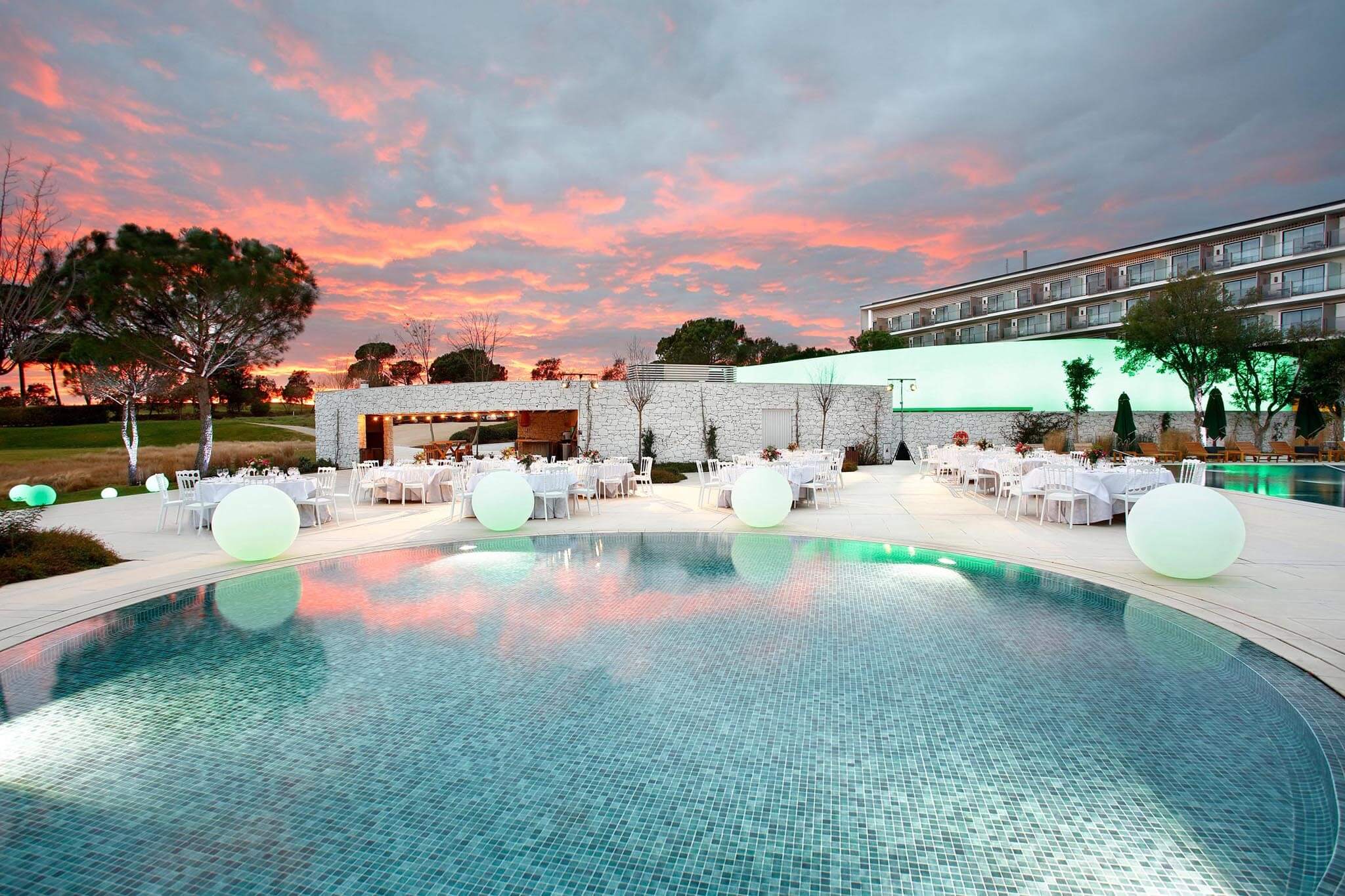 Dusk settles over the PGA Catalunya Golf Resort pool and main buildings in Spain