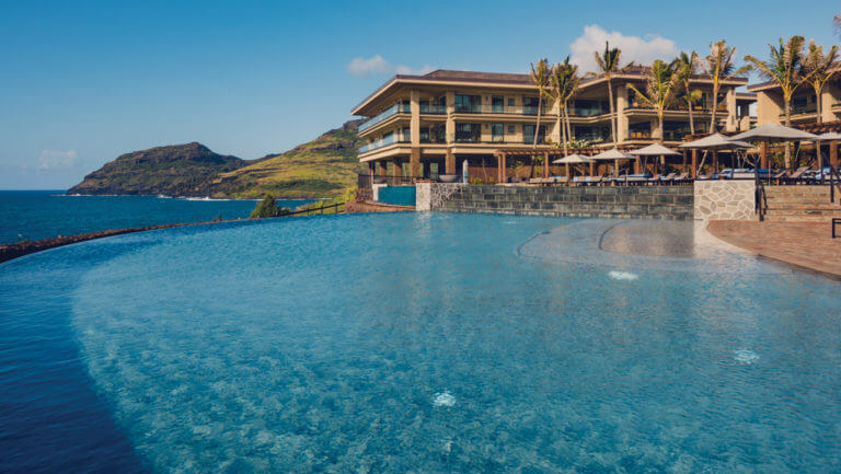 An infinity pool looks out towards the Pacific Ocean at Timbers Golf Resort in Hawaii