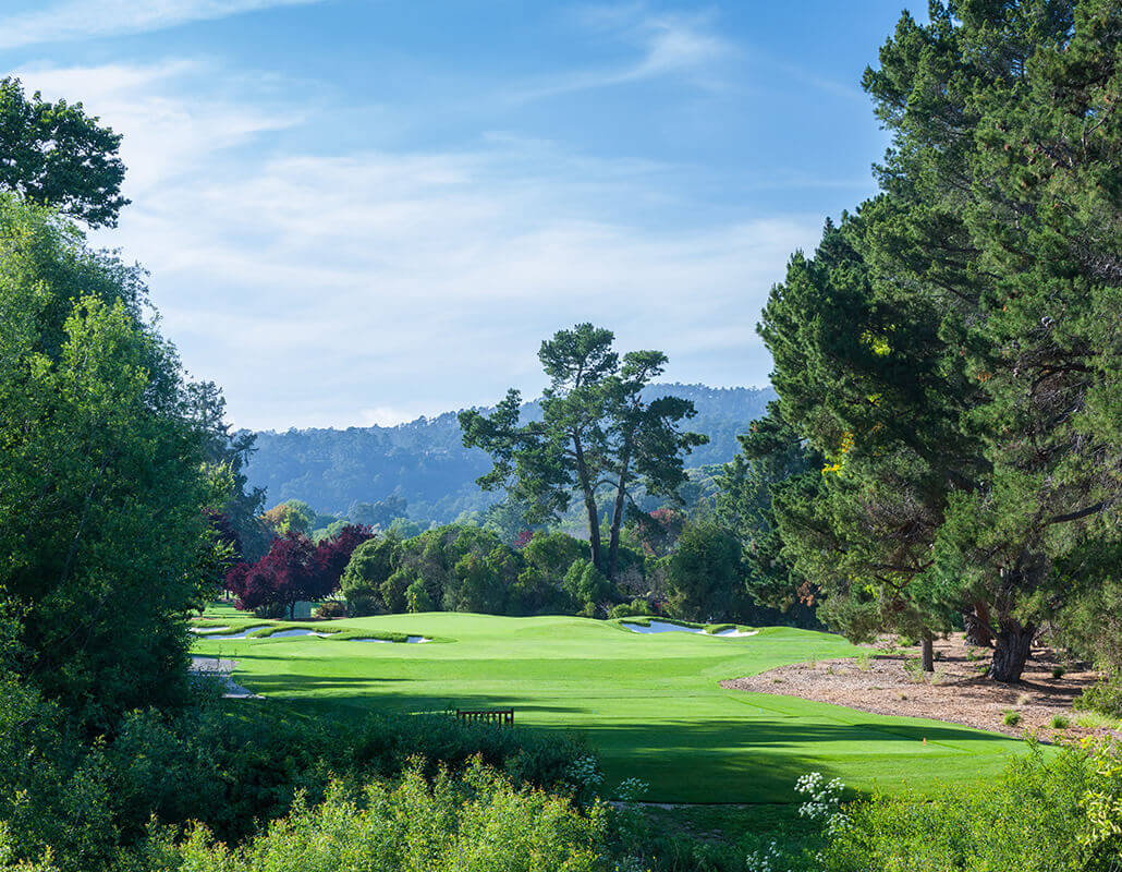 Looking down the fairway of the twelfth hole surrounded by large pine trees at Quail Lodge in California