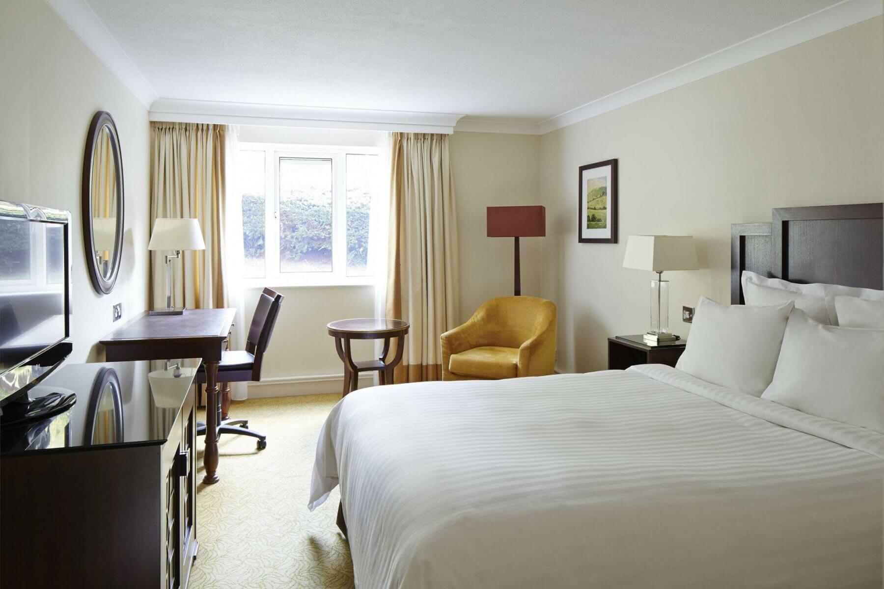 A comfortable bed with T.V and separate writing desk