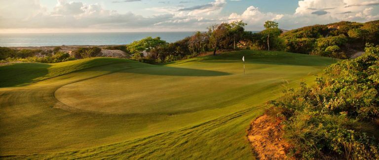 Golf green at dusk overlooking South China Sea