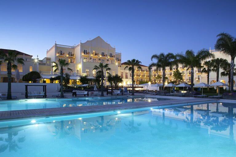 External twilight view of pool and Resort building